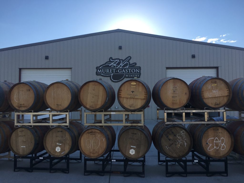 Stacks of wine barrels sit in front of Purple Star Winery's tasting room.