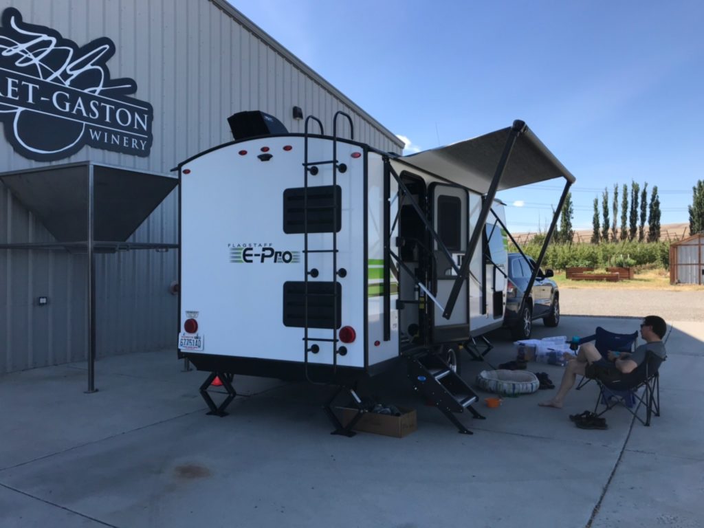 A travel trailer sits in front of the Purple Star Winery tasting room.
